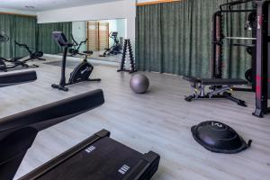 a gym with several treadmills and exercise bikes at Villa Dynamic Els Ports Resort in Arnés