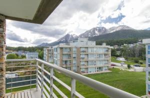 a balcony with a view of a city and mountains at Pacífico Apartamentos Ribera in Ushuaia