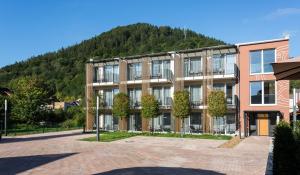 a large building with a mountain in the background at EMICH´S Hotel in Amorbach