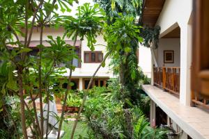 a courtyard in a house with trees and plants at Esther's Hotel in Accra
