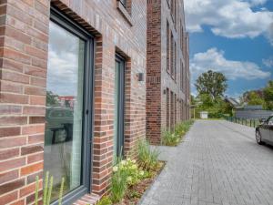 a brick building with a window on a street at Gästehaus linda&otto in Achim