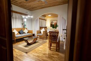 a living room with a couch and a table and chairs at Esther's Hotel in Accra