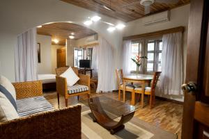 a living room with a couch and a table at Esther's Hotel in Accra +100 photos
