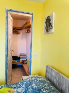a bedroom with a bed and a door to a closet at Casa Laranja Santa Maria in Santa Maria