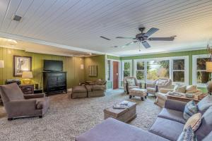 a living room with furniture and a ceiling fan at 4 Bedroom Retreat with Game Room and Creek Access in Pawleys Island