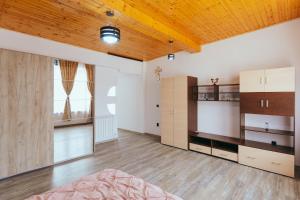 a room with a bed and a wooden ceiling at Casa Selly in Tulcea