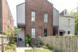 a brick house with a fence in front of it at Historic Benton Park Townhome in Soulard