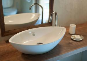 a white bowl sink on a counter in a bathroom at Tiger Tops Karnali Lodge in Bardiyā