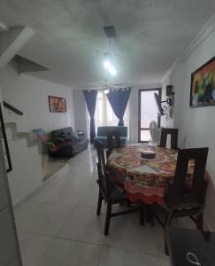 a dining room table and chairs in a living room at Casa Amoblada en Conjunto Cerrado in Villavicencio