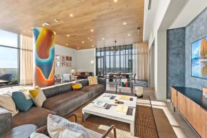 a living room with a couch and a table at NEW 1BR Scenic Retreat with Rooftop pool on Rainey St in Austin