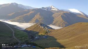 a view of a mountain with clouds in a valley at Mountain house in Xınalıq