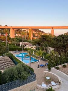 a view of a swimming pool with a bridge in the background at Hotel Costa Azul in Balestrate