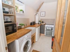 a small kitchen with a washer and dryer at Whitehedge in York