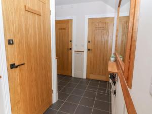 a hallway with two wooden doors and a tile floor at Whitehedge in York