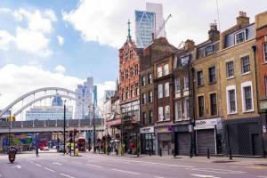 una concurrida calle de la ciudad con edificios y un puente en Luxe Prime 3 Beds Apartment in Central London, en Londres