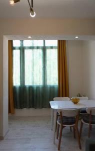 a table and chairs in a room with a window at Platanus in Trebinje