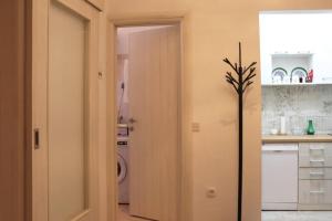 a kitchen with a door open to a laundry room at Platanus in Trebinje