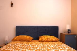 a bedroom with a bed with two pillows on it at Platanus in Trebinje