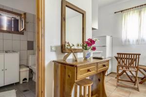 a bathroom with a wooden dresser and a mirror at Garden House Lefkada in Lygia