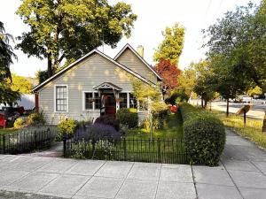 a house with a fence in front of it at Fireside Cottage in Jacksonville