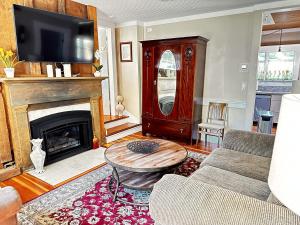 a living room with a couch and a fireplace at Fireside Cottage in Jacksonville