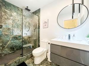 a bathroom with a shower and a toilet and a sink at Modern 2BR Oasis - Cal-Cal in Calabasas
