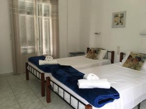 two beds in a room with towels on them at Bay Apartments - Kalami by Sunvil in Kalami