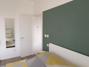 a bedroom with a bed and a mirror at La casetta di Cecilia in Trani