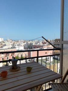 a table on a balcony with a view of a city at La casetta di Cecilia in Trani