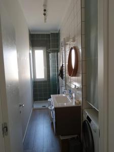 a bathroom with a sink and a mirror at La casetta di Cecilia in Trani +6 photos