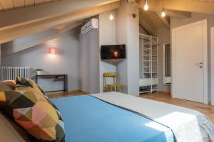 a bedroom with a bed and a tv on the wall at Le Casette del Balon by Wonderful Italy in Turin