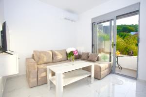 a living room with a couch and a table at NESI Apartments in Ulcinj