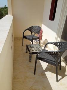 two chairs and a table on a balcony at الغردقه البحر الاحمر مبارك 6 in Hurghada