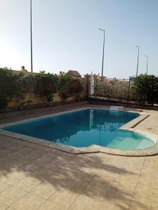a small swimming pool in a yard with a fence at الغردقه البحر الاحمر مبارك 6 in Hurghada