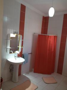 a bathroom with a sink and a red shower curtain at الغردقه البحر الاحمر مبارك 6 in Hurghada