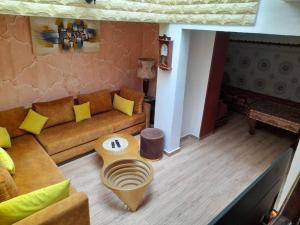 a living room with a couch and a table at Chez ouaki in Salé