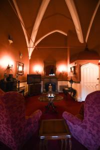 a living room with chairs and a table and a fireplace at Lumley Castle Hotel in Chester-le-Street
