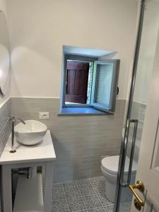 a bathroom with a sink and a toilet and a mirror at Forca de Cerro in Spoleto