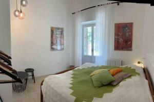 a bedroom with a bed with green pillows on it at Forca de Cerro in Spoleto