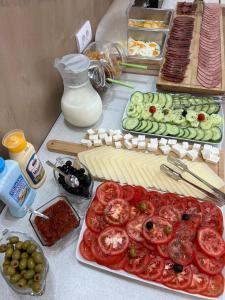 a table with many different types of food on it at Apart-Hotel President in Ulcinj
