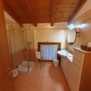 a bathroom with a shower toilet and a sink at GARDAINN La CASCINA in Riva del Garda