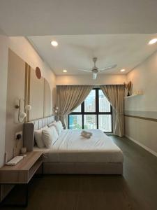 a bedroom with a large bed and a window at OOAK SUITES AT MONT KIARA KUALA LUMPUR in Kuala Lumpur