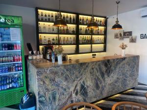 a bar with a marble counter and bottles of alcohol at Wolf Of The City Hotel & Spa in Antalya