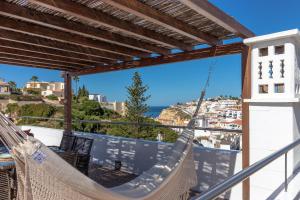 a hammock on the balcony of a house at Casa Ayla in Carvoeiro