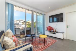a living room with a couch and a large window at Casa Ayla in Carvoeiro