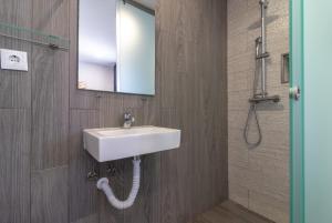 a bathroom with a sink and a mirror and a shower at Casa Ayla in Carvoeiro +18 photos
