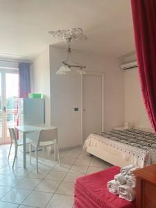 a bedroom with a bed and a table and chair at Stars Home in Tropea