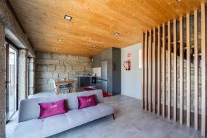 - un salon avec un canapé et un plafond en bois dans l'établissement Quinta das Carvoeiras, à Vieira do Minho