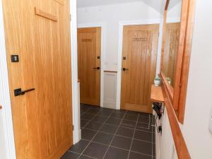 a hallway with two wooden doors and a tile floor at Penny in York