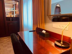 a dining room with a glass table and a lamp at Gatsby Hotel - Adults Only - Restaurant - Small Luxury Hotel by F-Hotels in Blankenberge +106 photos